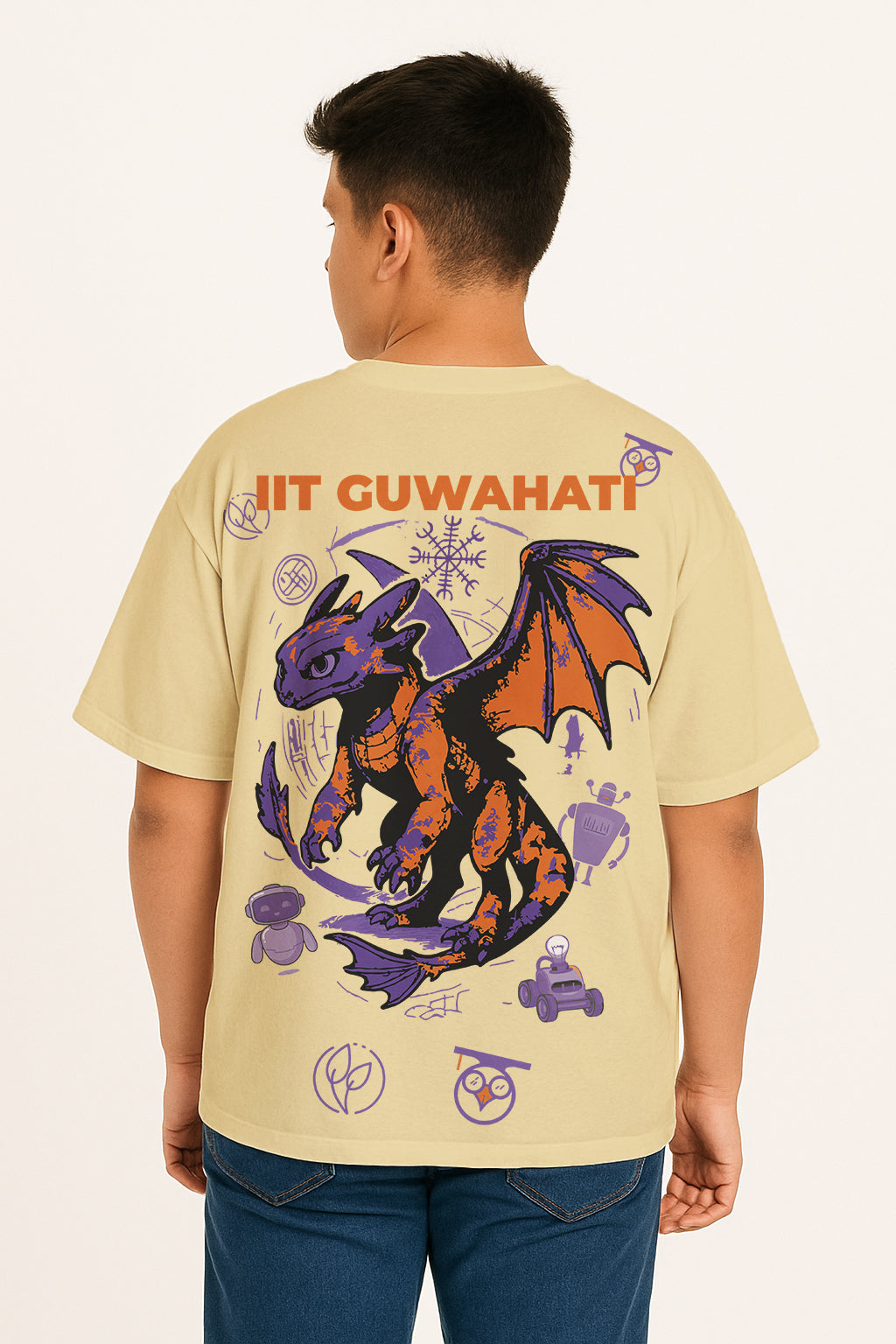 Person wearing a beige t-shirt with a dragon graphic and text on the back. for technothlon iit guwahati exam. technothlon.