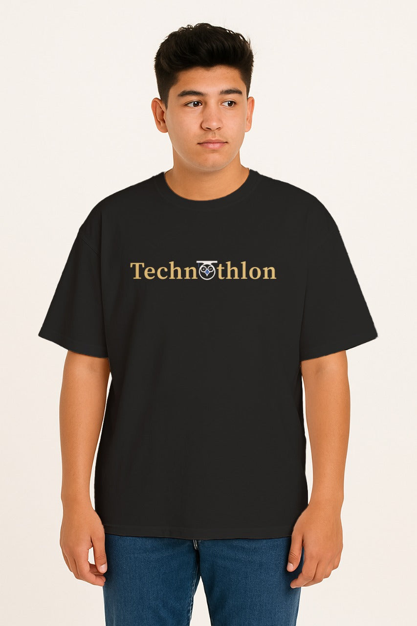Person wearing a black t-shirt with 'Technothlon' text on a beige background. iit guwahati technothlon.